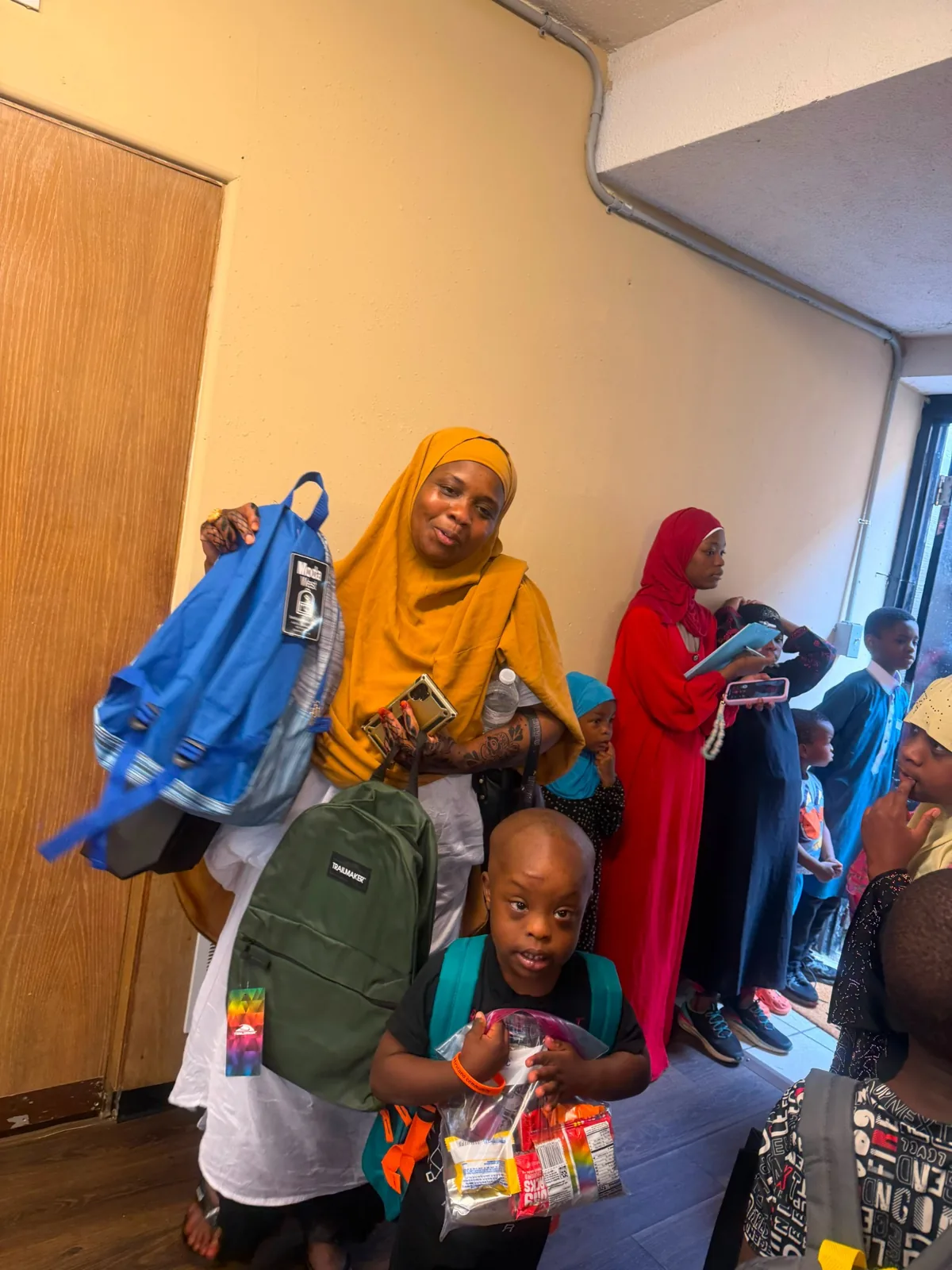 A family receiving backpacks and school supplies during the August 2 event.