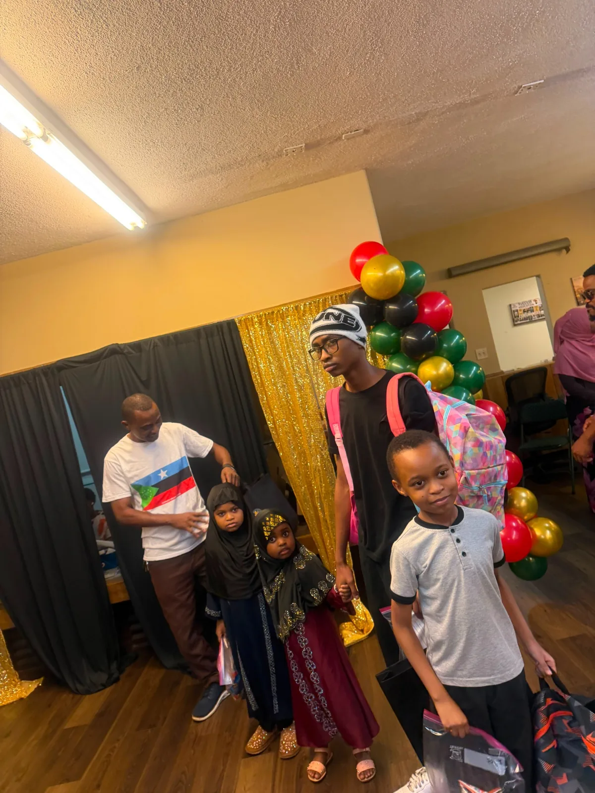 Children and families receiving backpacks at Afrikana Community Center
