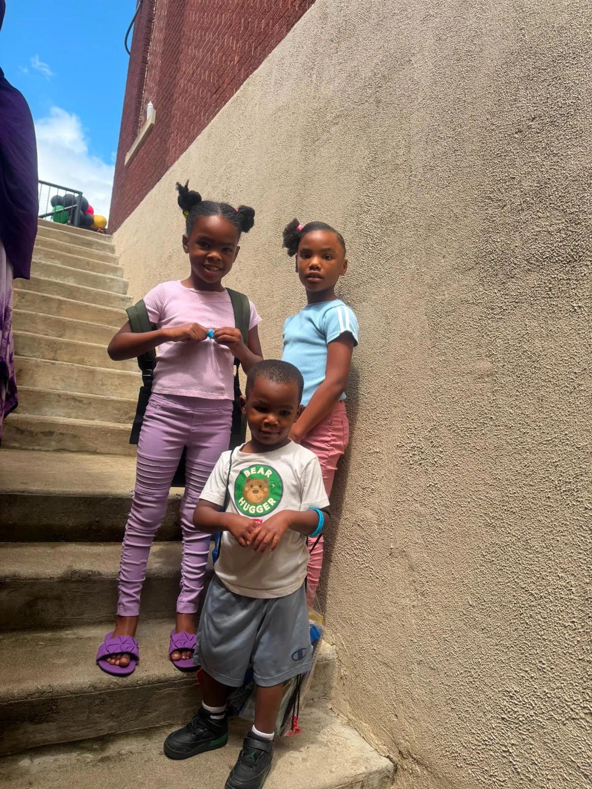 Children receiving school supplies and community support.