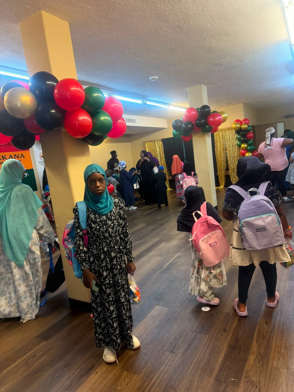 Families and students gathering inside Afrikana Community Center during the August 2 giveaway.