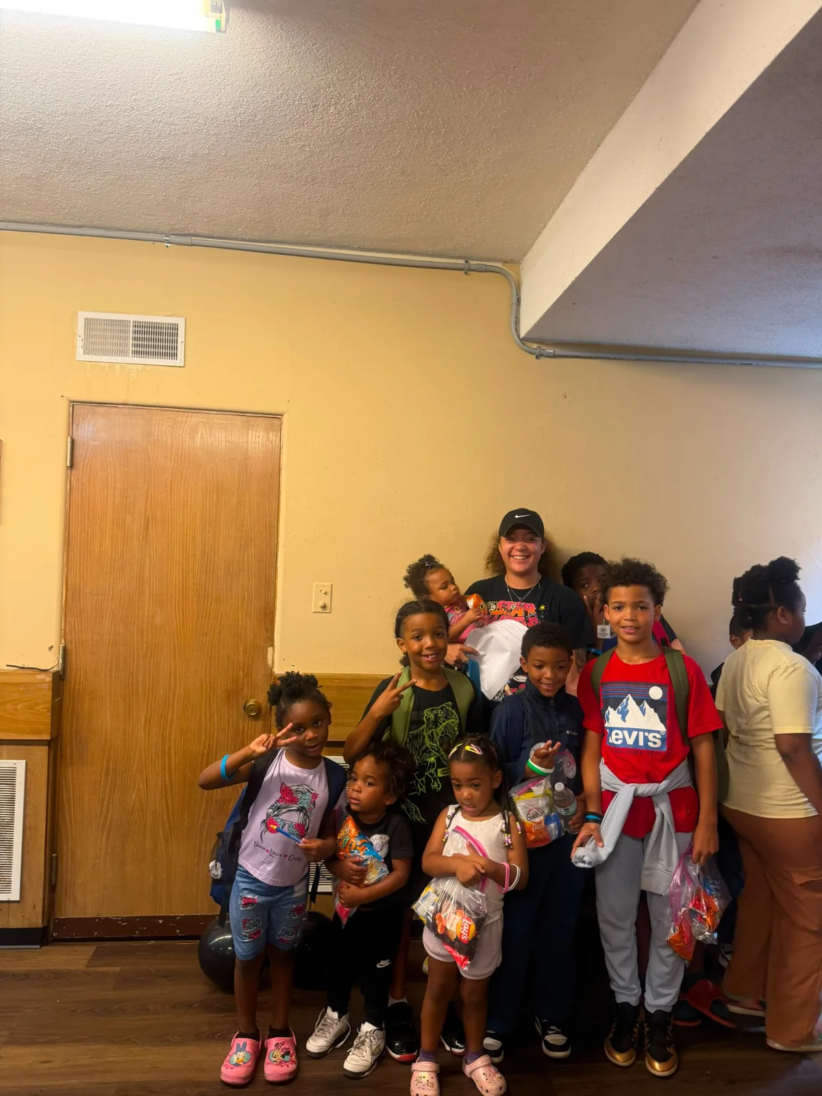 Family receiving backpacks at Afrikana Community Center's 2026 giveaway
