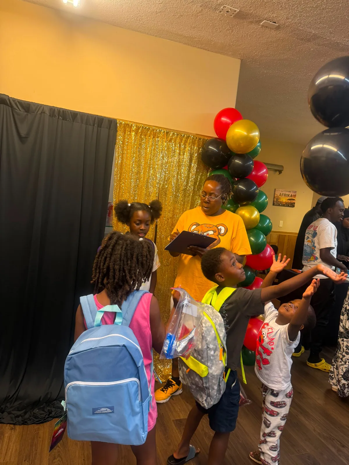 Volunteers and families connecting during the community giveaway.