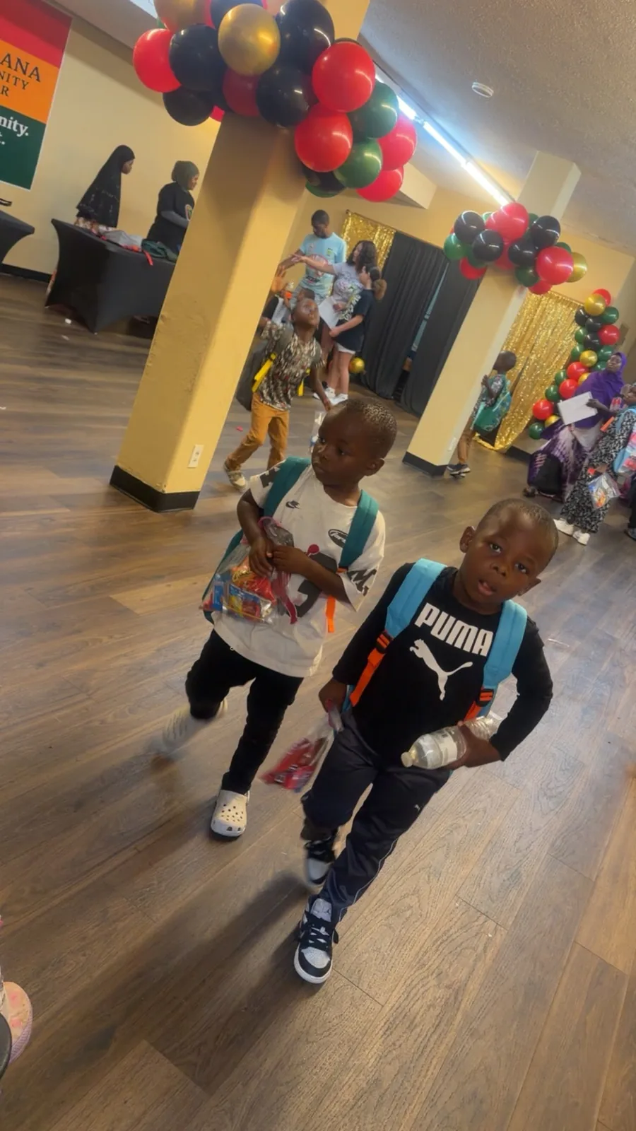 Young students leaving Afrikana with backpacks and supplies.