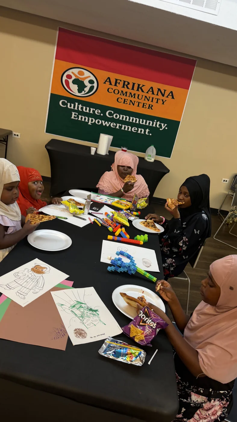 Children coloring and creating together at Afrikana Community Center.